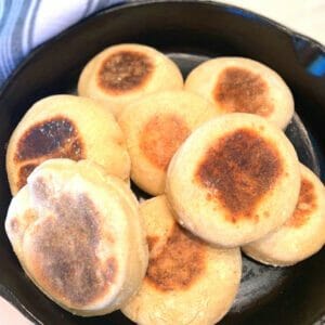 sourdough english muffins in a cast iron skillet