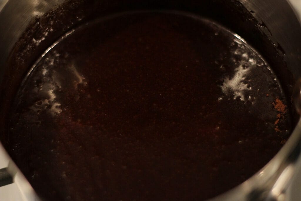 cocoa powder, maple syrup, brown sugar, coconut oil, and salt melted and mixed in a saucepan