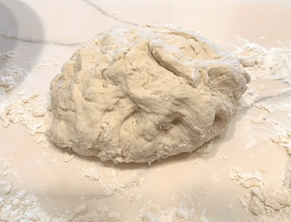 dough laying on a floured counter