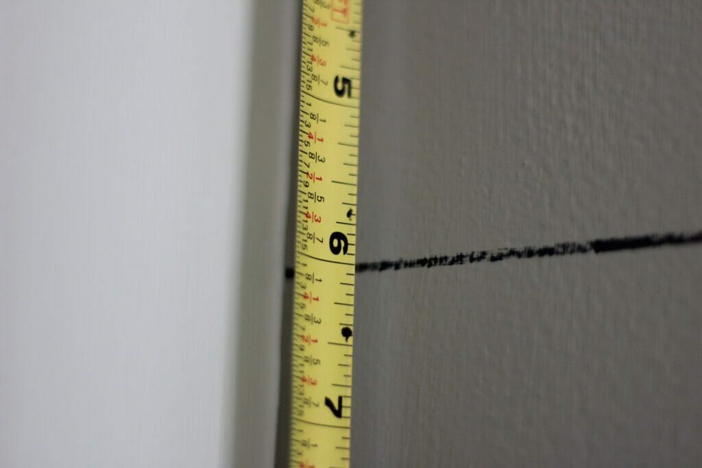 measure tape showing six inches between horizontal lines on wall