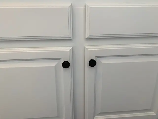 white cabinets with black knobs
