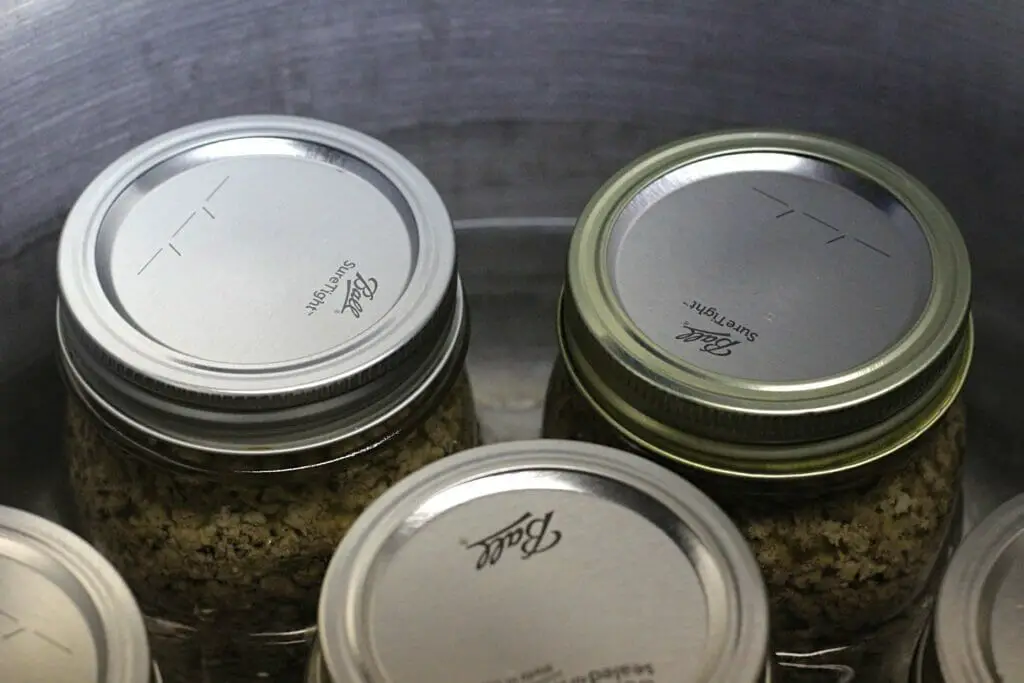 sealed canning jars in a pressure canner