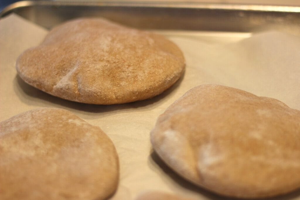 pita rounds baking in an oven