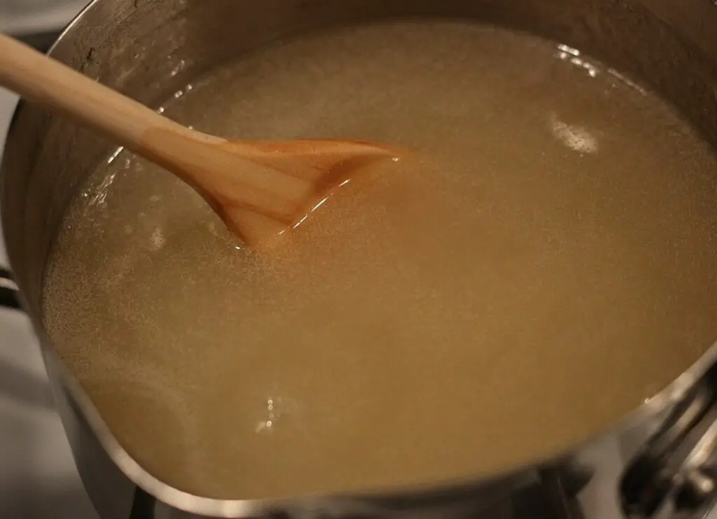 warm vanilla hard sauce in a pot on the stove