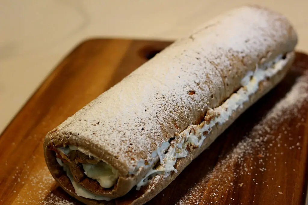 Sourdough carrot cake roll with powdered sugar