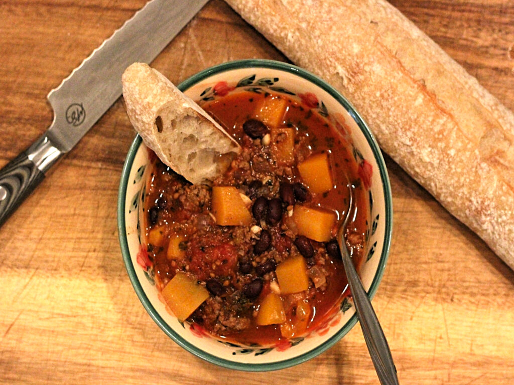 bowl of butternut squash soup with baguette 