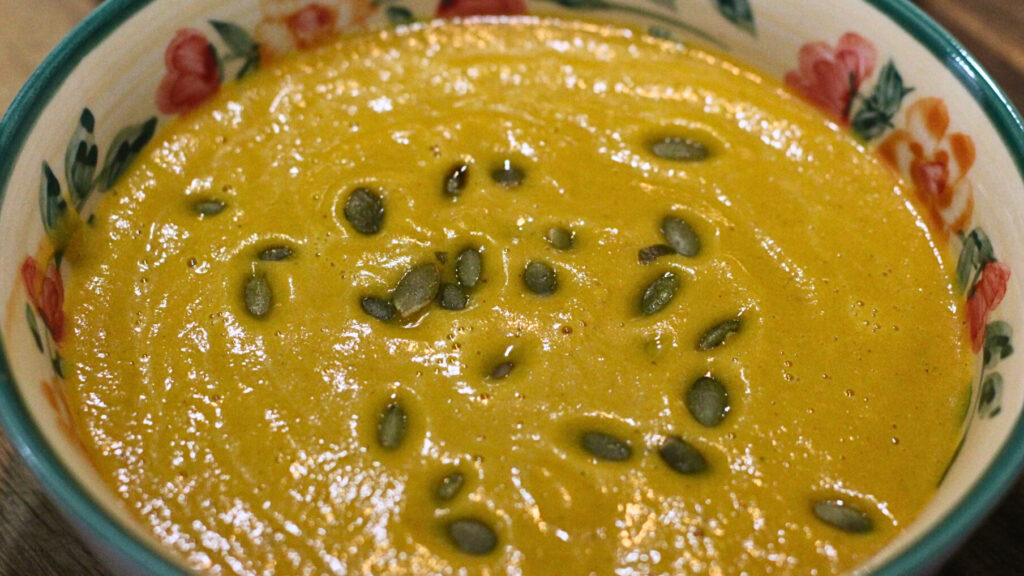 carrot ginger soup topped with roasted pumpkin seeds