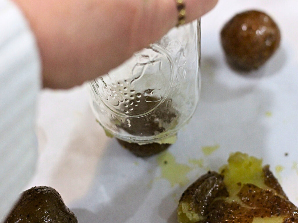 smashing a potato with the bottom of a glass jar